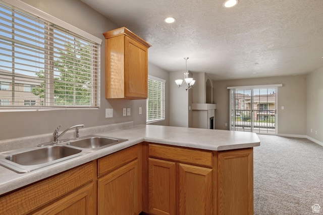 211 E Spencer Peak Way Unit H6, Draper, UT 84020 - kitchen featuring a textured ceiling, a peninsula, light colored carpet, light countertops, and open floor plan