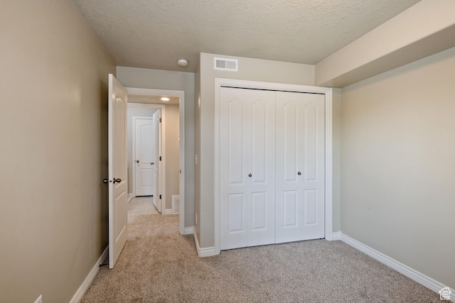 211 E Spencer Peak Way Unit H6, Draper, UT 84020 - unfurnished bedroom featuring light colored carpet, a textured ceiling, and a closet