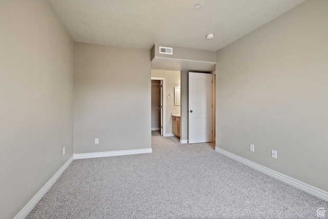 211 E Spencer Peak Way Unit H6, Draper, UT 84020 - unfurnished bedroom with light carpet, a textured ceiling, and a walk in closet