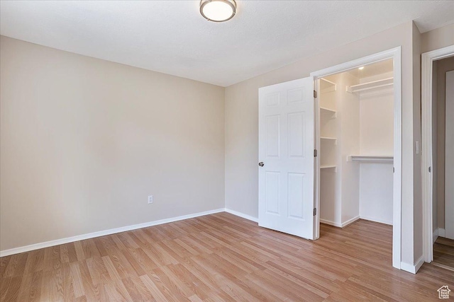 315 E 900 N, Brigham City, UT 84302 - unfurnished bedroom featuring light wood-style floors, a spacious closet, and a closet
