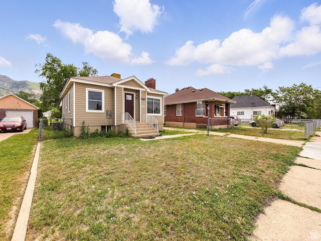 1116 S Liberty Ave, Ogden, UT 84404 - bungalow-style house with a chimney, a garage, driveway, and a mountain view