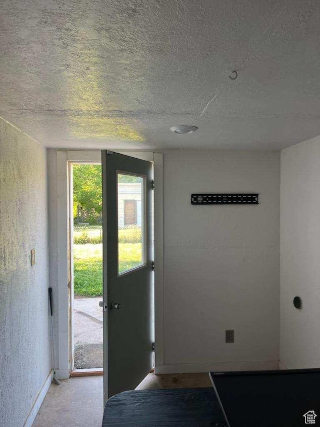 1116 S Liberty Ave, Ogden, UT 84404 - doorway to outside featuring a textured ceiling