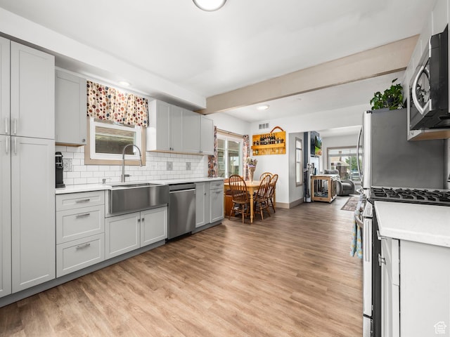 1116 S Liberty Ave, Ogden, UT 84404 - kitchen with stainless steel appliances, light countertops, backsplash, light wood-style floors, and recessed lighting