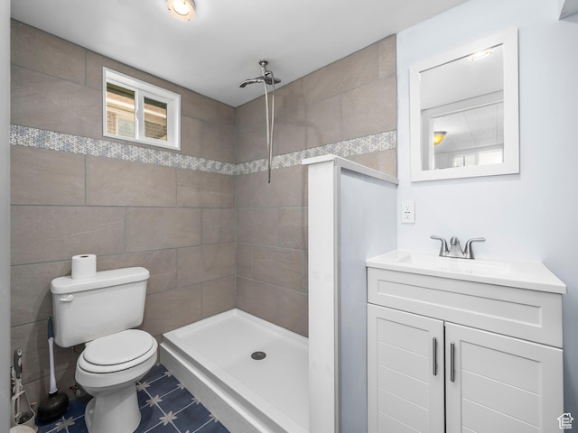 1116 S Liberty Ave, Ogden, UT 84404 - bathroom featuring a tile shower, vanity, and tile walls