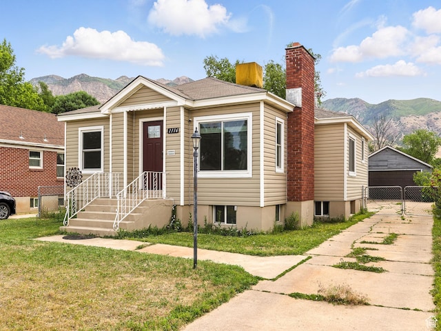 1116 S Liberty Ave, Ogden, UT 84404 - view of front of property with a mountain view, a chimney, and a detached garage