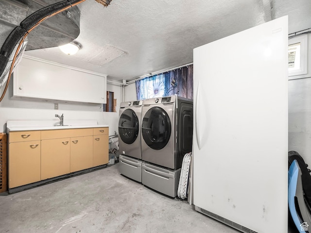 1116 S Liberty Ave, Ogden, UT 84404 - laundry room with washer and dryer, cabinet space, and a textured ceiling