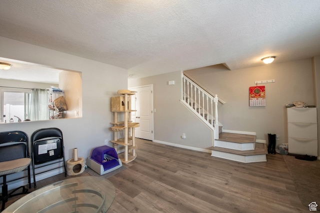 3408 S Carrick Dr W, South Salt Lake, UT 84115 - living room featuring wood finished floors, stairs, and a textured ceiling
