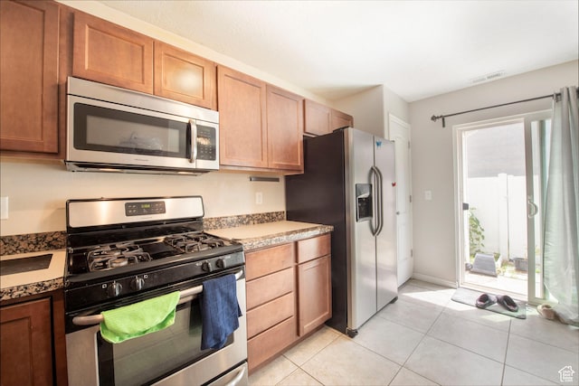 3408 S Carrick Dr W, South Salt Lake, UT 84115 - kitchen with appliances with stainless steel finishes and light tile patterned floors