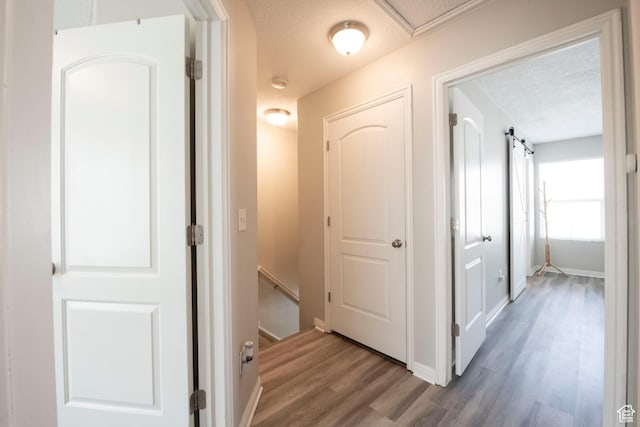 3408 S Carrick Dr W, South Salt Lake, UT 84115 - hall with a textured ceiling, wood finished floors, and an upstairs landing