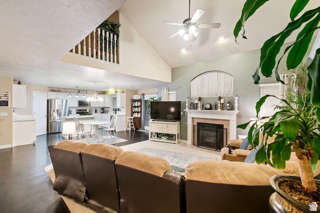 969 S Cove Rd, Saratoga Springs, UT 84045 - living room with ceiling fan, high vaulted ceiling, a tile fireplace, and dark wood-style floors