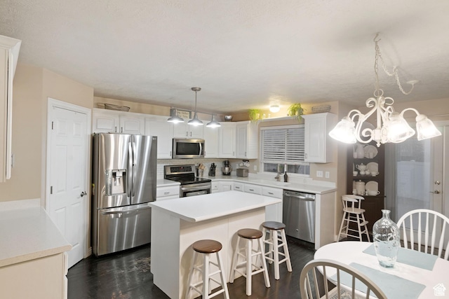 969 S Cove Rd, Saratoga Springs, UT 84045 - kitchen featuring stainless steel appliances, a center island, white cabinets, and dark wood-style flooring