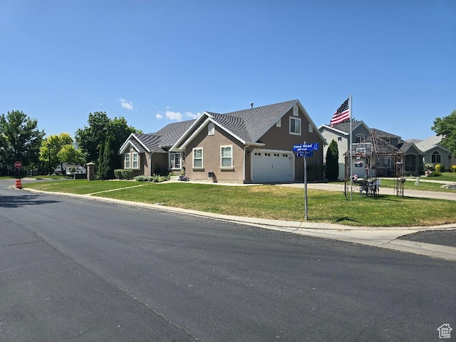 969 S Cove Rd, Saratoga Springs, UT 84045 - view of front of property featuring a garage, a front lawn, stucco siding, and driveway
