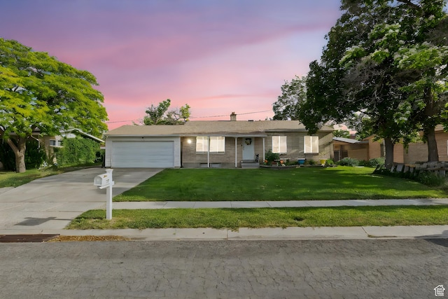 4895 W Pavant Ave, West Valley City, UT 84120 - ranch-style home featuring a garage, driveway, a front yard, and brick siding
