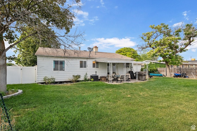 4895 W Pavant Ave, West Valley City, UT 84120 - back of house featuring a patio area, a fenced backyard, and a chimney
