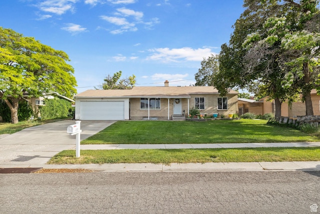 4895 W Pavant Ave, West Valley City, UT 84120 - ranch-style house with a garage, brick siding, concrete driveway, and a front yard
