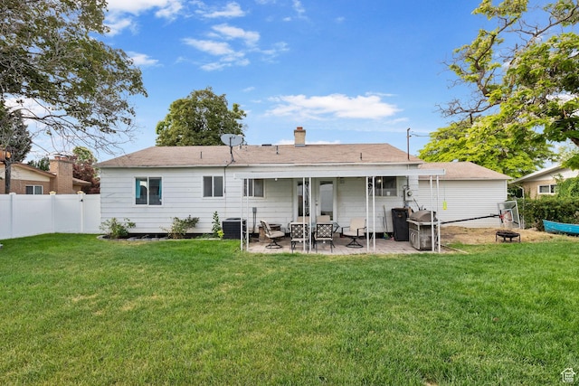 4895 W Pavant Ave, West Valley City, UT 84120 - back of property featuring a fire pit, a patio, and a chimney