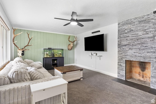 4895 W Pavant Ave, West Valley City, UT 84120 - living room with ceiling fan, a stone fireplace, dark carpet, and a textured ceiling