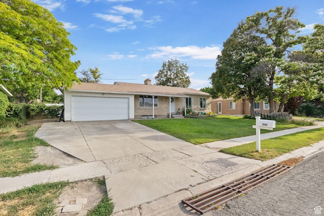4895 W Pavant Ave, West Valley City, UT 84120 - single story home with an attached garage, a front lawn, driveway, and a chimney