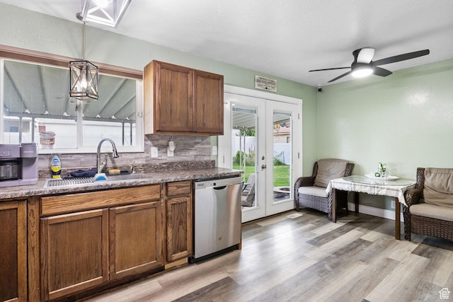 4895 W Pavant Ave, West Valley City, UT 84120 - kitchen featuring dishwasher, french doors, decorative backsplash, brown cabinetry, and ceiling fan