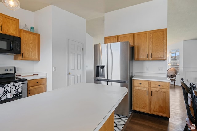 387 W 1900 S, Clearfield, UT 84015 - kitchen with stainless steel appliances, wood finished floors, light countertops, and brown cabinetry