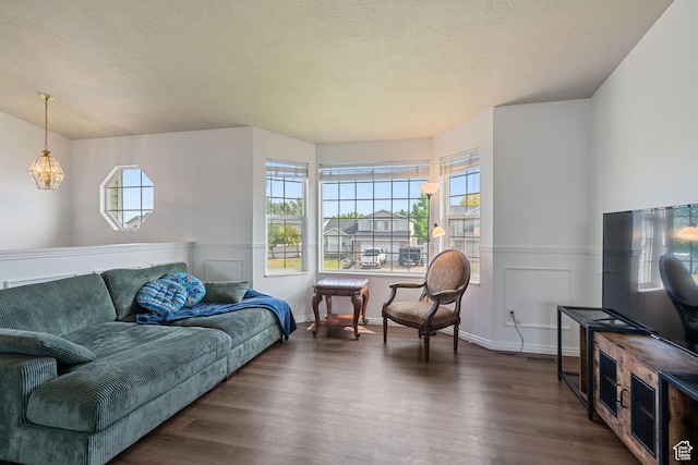 387 W 1900 S, Clearfield, UT 84015 - living area with dark wood finished floors, healthy amount of natural light, wainscoting, and a textured ceiling