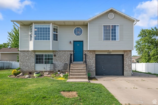 387 W 1900 S, Clearfield, UT 84015 - raised ranch with a garage, driveway, and brick siding