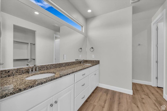 424 N Highland Pkwy, Washington, UT 84780 - full bathroom featuring wood finished floors, double vanity, and recessed lighting