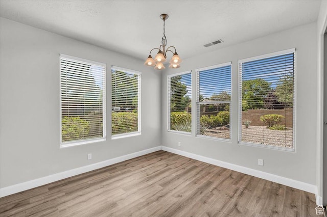 424 N Highland Pkwy, Washington, UT 84780 - unfurnished dining area featuring wood finished floors and a chandelier