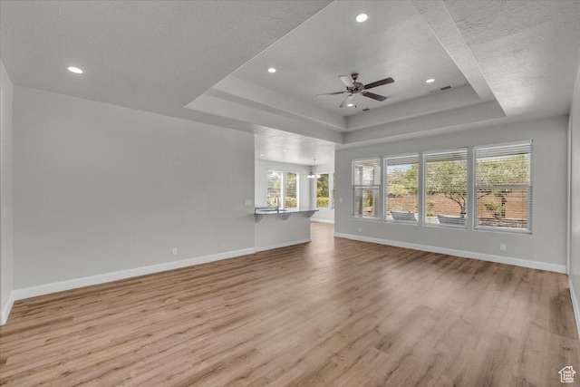 424 N Highland Pkwy, Washington, UT 84780 - unfurnished living room with a raised ceiling, wood finished floors, a textured ceiling, ceiling fan, and recessed lighting