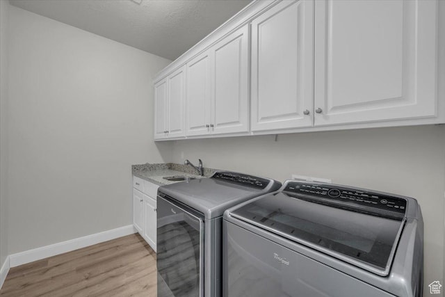 424 N Highland Pkwy, Washington, UT 84780 - laundry area with cabinet space, washer and clothes dryer, and light wood-style flooring