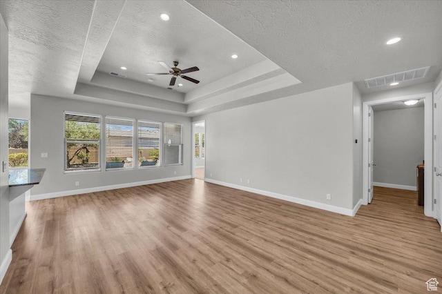 424 N Highland Pkwy, Washington, UT 84780 - unfurnished living room featuring a textured ceiling, light wood-style floors, ceiling fan, a raised ceiling, and recessed lighting
