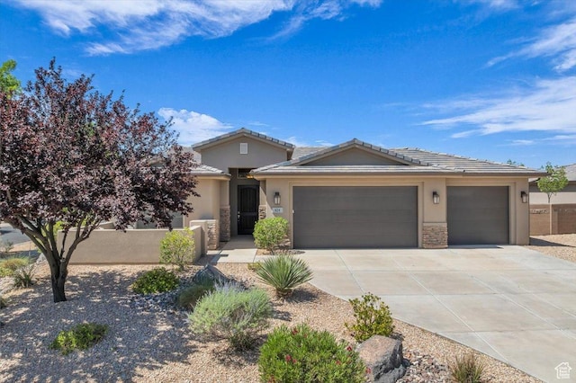 424 N Highland Pkwy, Washington, UT 84780 - view of front of house featuring stucco siding, concrete driveway, an attached garage, and stone siding