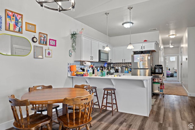 4064 W 1850 N Unit F302, Lehi, UT 84043 - kitchen with fridge, stainless steel microwave, dark wood-style flooring, a peninsula, and tasteful backsplash