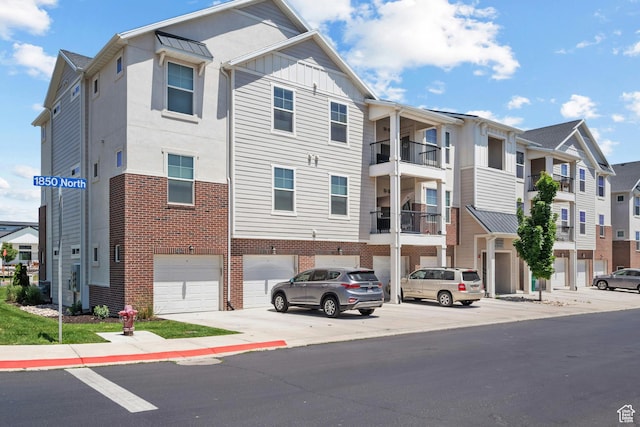 4064 W 1850 N Unit F302, Lehi, UT 84043 - view of building exterior with a garage and driveway
