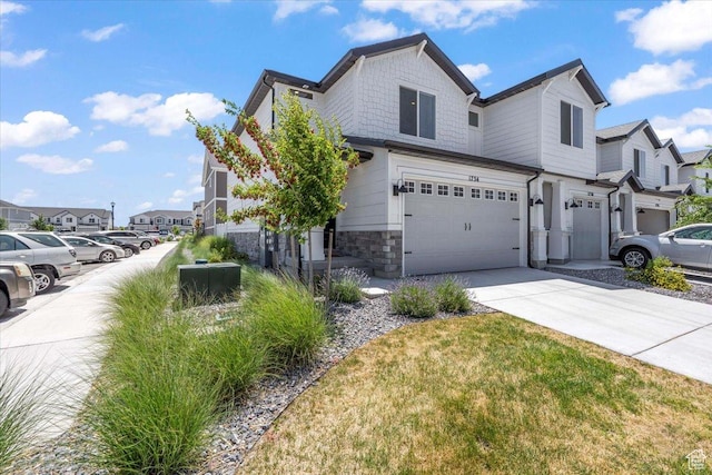 1734 E Muss Dr, Eagle Mountain, UT 84005 - view of side of home featuring a garage, concrete driveway, stone siding, and a residential view