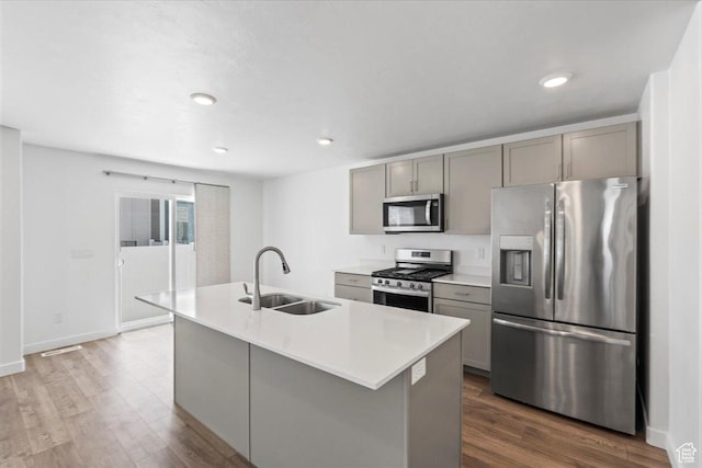1734 E Muss Dr, Eagle Mountain, UT 84005 - kitchen with stainless steel appliances, gray cabinetry, dark wood-style floors, light countertops, and recessed lighting