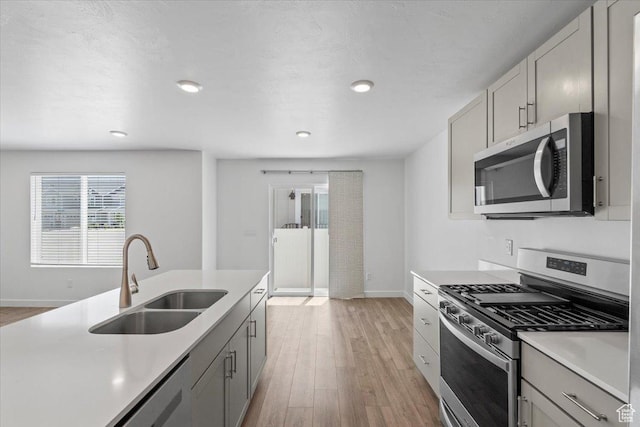1734 E Muss Dr, Eagle Mountain, UT 84005 - kitchen with appliances with stainless steel finishes, light wood finished floors, healthy amount of natural light, light countertops, and recessed lighting