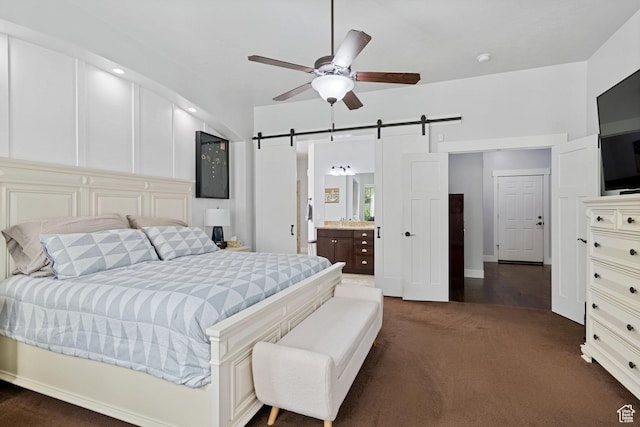 6923 W Long Ridge Dr S, Herriman, UT 84096 - bedroom with a barn door, dark carpet, ensuite bath, and a ceiling fan