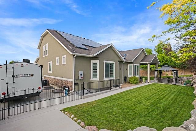 6923 W Long Ridge Dr S, Herriman, UT 84096 - rear view of house featuring a gazebo, solar panels, stucco siding, a patio, and an outdoor hangout area