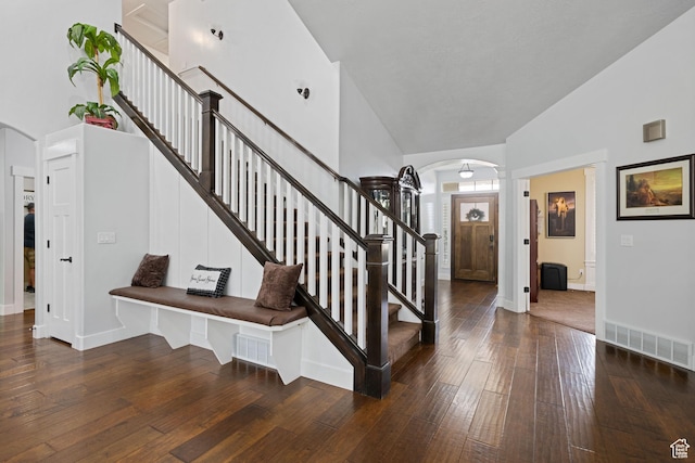 6923 W Long Ridge Dr S, Herriman, UT 84096 - foyer entrance with arched walkways, high vaulted ceiling, wood-type flooring, and stairway