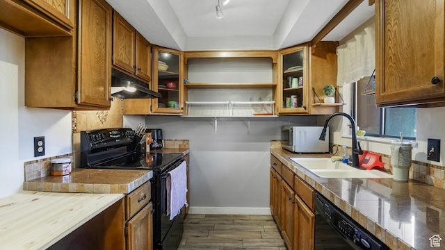5667 S Aspen Ct E, South Ogden, UT 84403 - kitchen with black appliances, under cabinet range hood, brown cabinets, glass insert cabinets, and open shelves