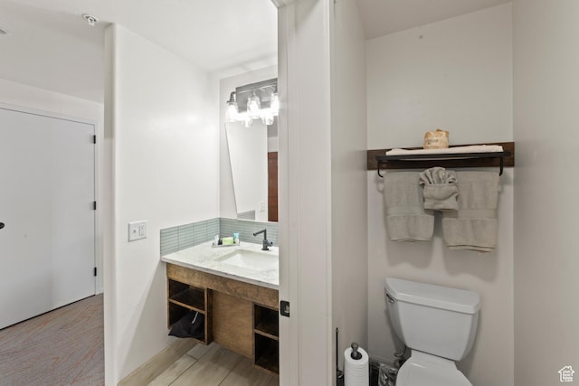 212 100 W 200 S Unit 212, Moab, UT 84532 - bathroom featuring vanity, decorative backsplash, and wood finished floors