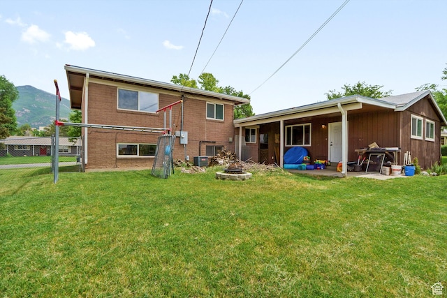 4299 Monroe Blvd, South Ogden, UT 84403 - back of house with an outdoor fire pit, a mountain view, and a patio