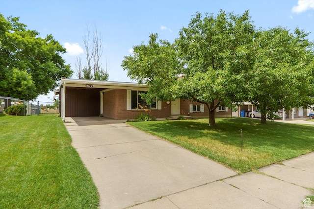 4299 Monroe Blvd, South Ogden, UT 84403 - view of front of property featuring driveway, a carport, a front lawn, and brick siding