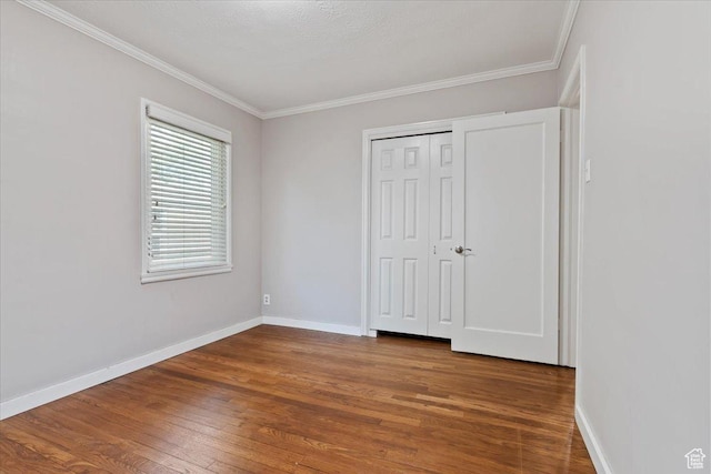 2009 E Hollywood Ave, Salt Lake City, UT 84108 - unfurnished bedroom featuring wood finished floors, ornamental molding, and a closet