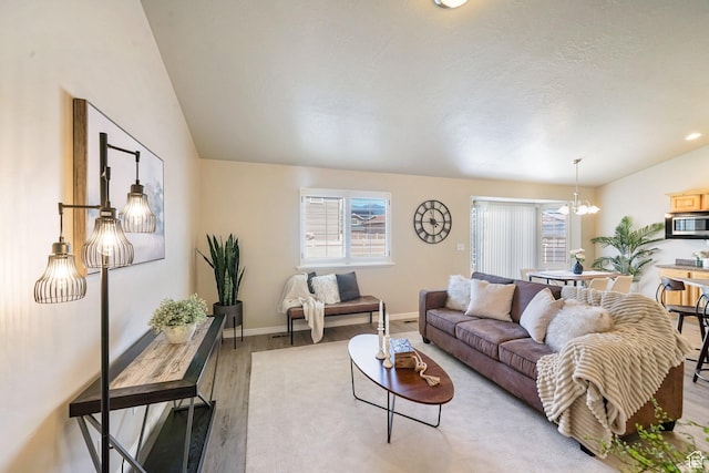 2051 E 1180 S, Spanish Fork, UT 84660 - living area featuring light wood-type flooring, a chandelier, and lofted ceiling
