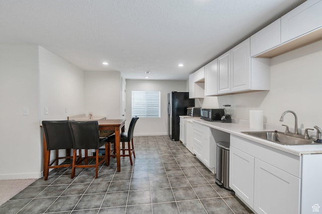 128 E 840 N, Santaquin, UT 84655 - kitchen featuring freestanding refrigerator, white cabinetry, recessed lighting, and light countertops
