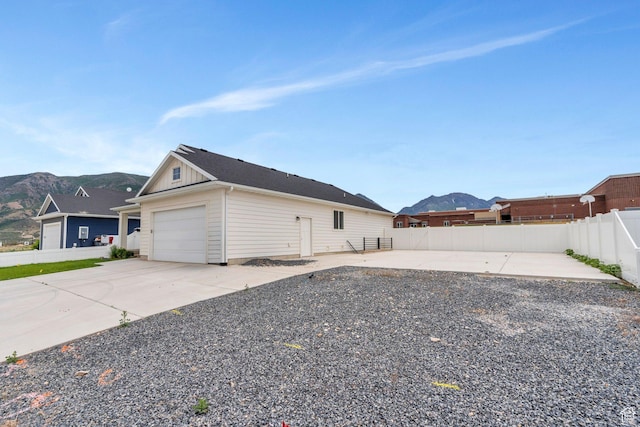 128 E 840 N, Santaquin, UT 84655 - view of property exterior featuring a mountain view, board and batten siding, an attached garage, and concrete driveway