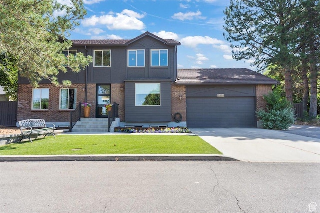 2494 E Murray Holladay Rd S, Holladay, UT 84117 - view of front of property featuring an attached garage, a front lawn, concrete driveway, and brick siding