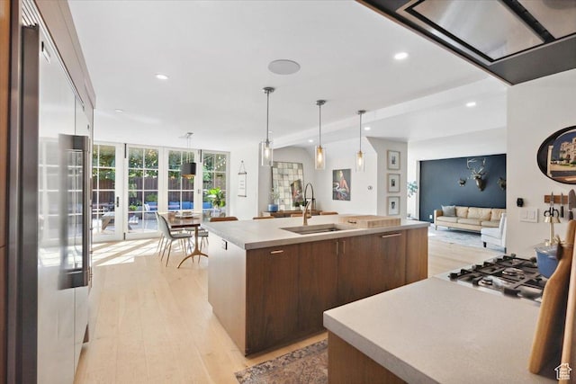 2494 E Murray Holladay Rd S, Holladay, UT 84117 - kitchen featuring appliances with stainless steel finishes, open floor plan, light wood-style flooring, modern cabinets, and recessed lighting